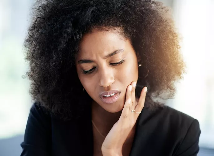 Woman suffering from tooth pain